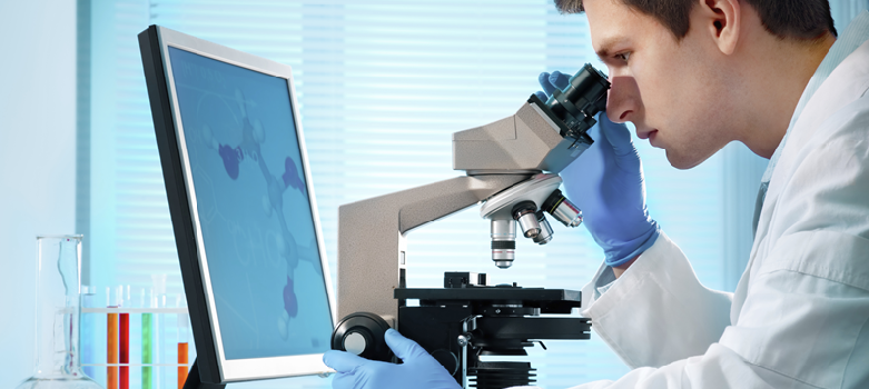 Scientist looking through a microscope in a medical laboratory
